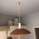 Vintage orange rust metal pendant light with opaline glass.