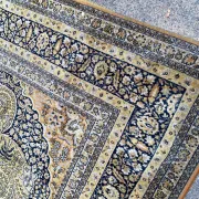 Large Persian wool rug 250x350 cm in gold and navy blue.