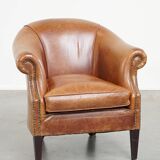 Very comfortable, elegant leather club armchair with a removable seat cushion and timeless design