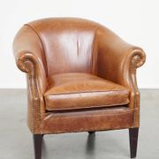 Very comfortable, elegant leather club armchair with a removable seat cushion and timeless design