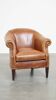 Very comfortable, elegant leather club armchair with a removable seat cushion and timeless design