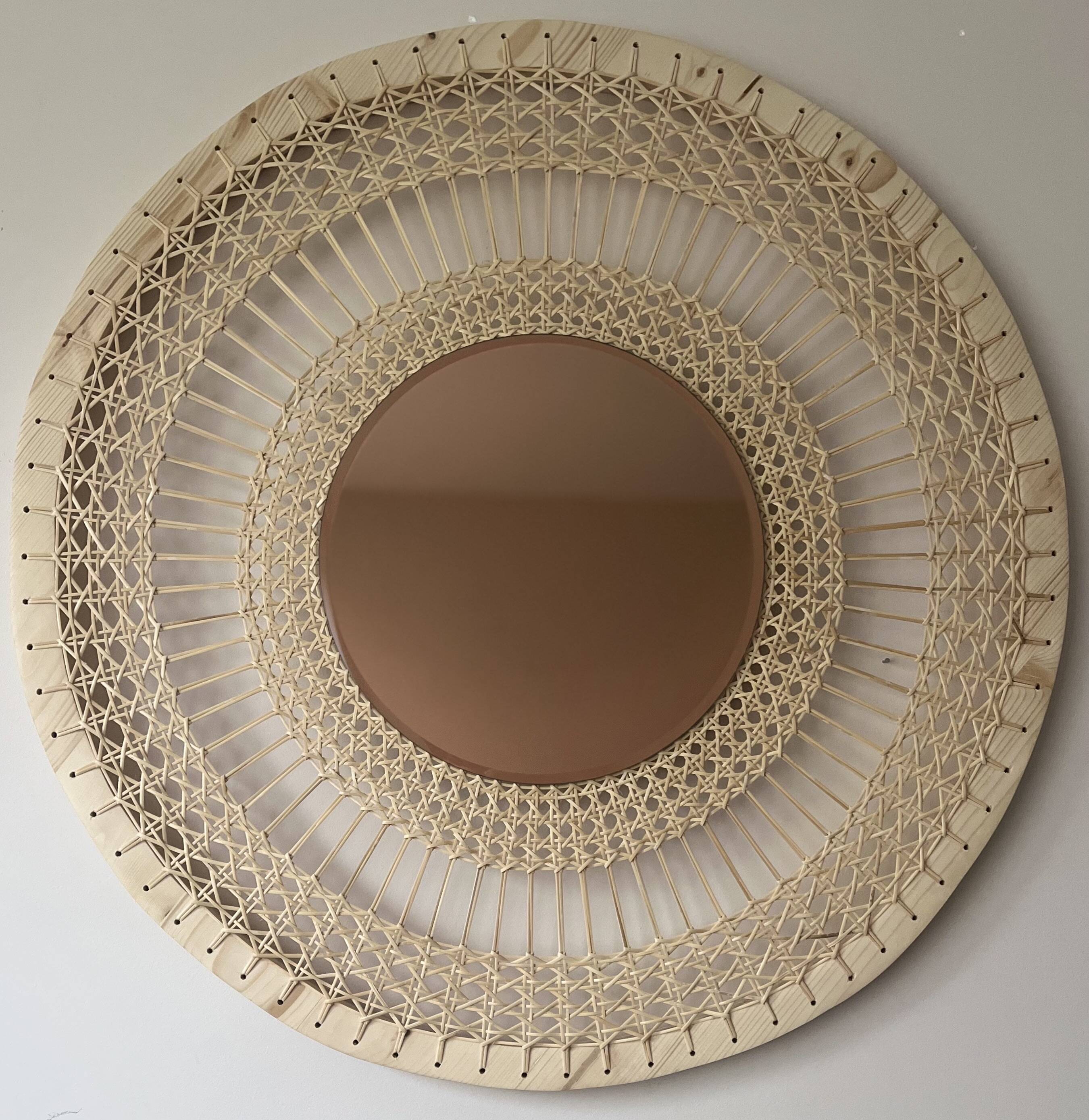Decorative mirror in woven sun cane
