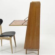 Vintage 1960s secretary desk with an angled design, light wood, and tapered legs.