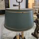 Three-armed brass hot water bottle lamp with empire green shade