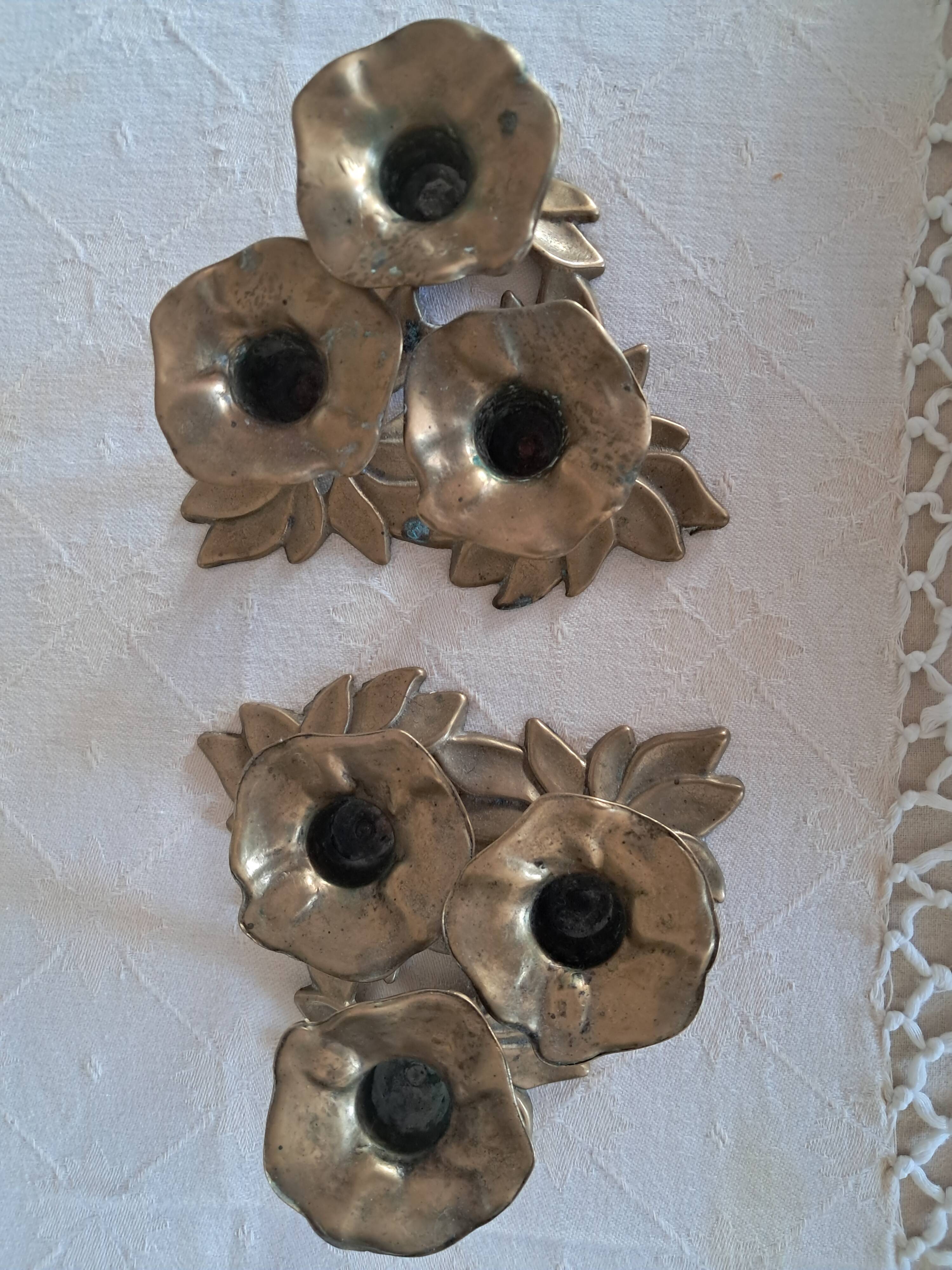 Pair of antique candlesticks with a floral design.