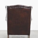 Comfortable wingback chair in English style made of cowhide leather