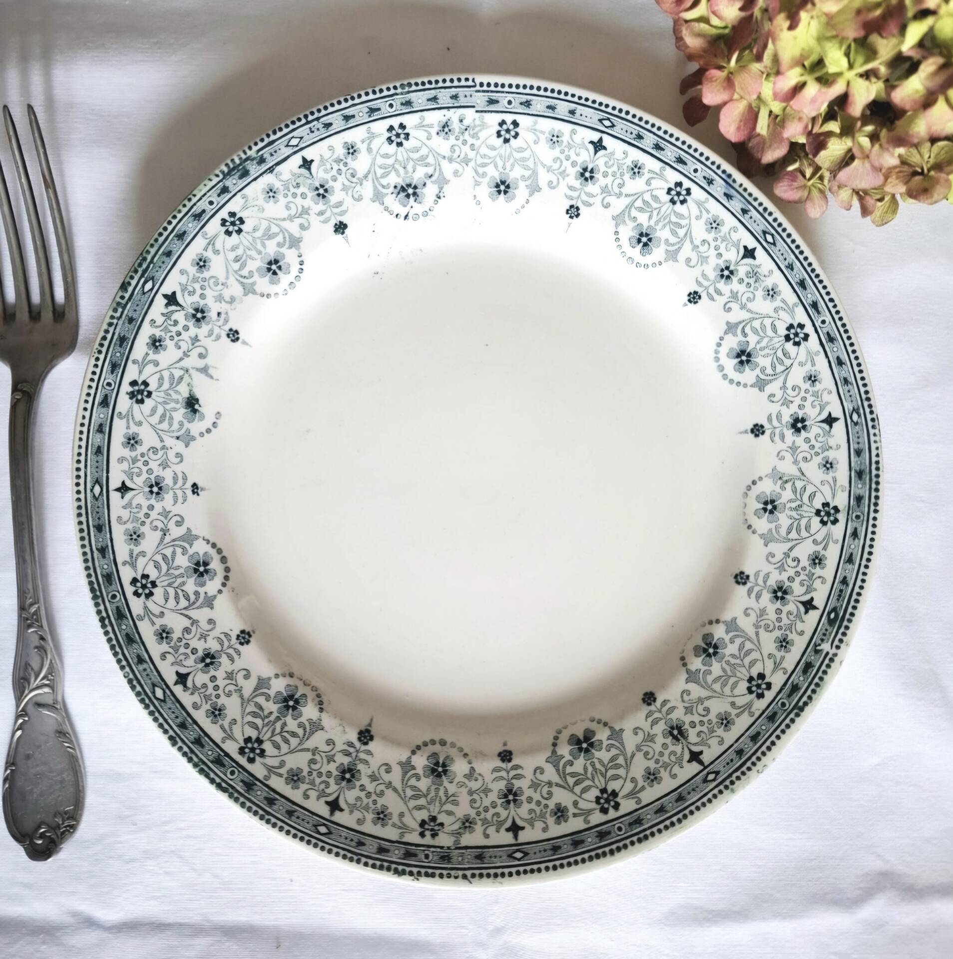 Old mismatched flat plates made of ironstone earthenware.