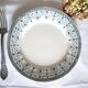 Old mismatched flat plates made of ironstone earthenware.