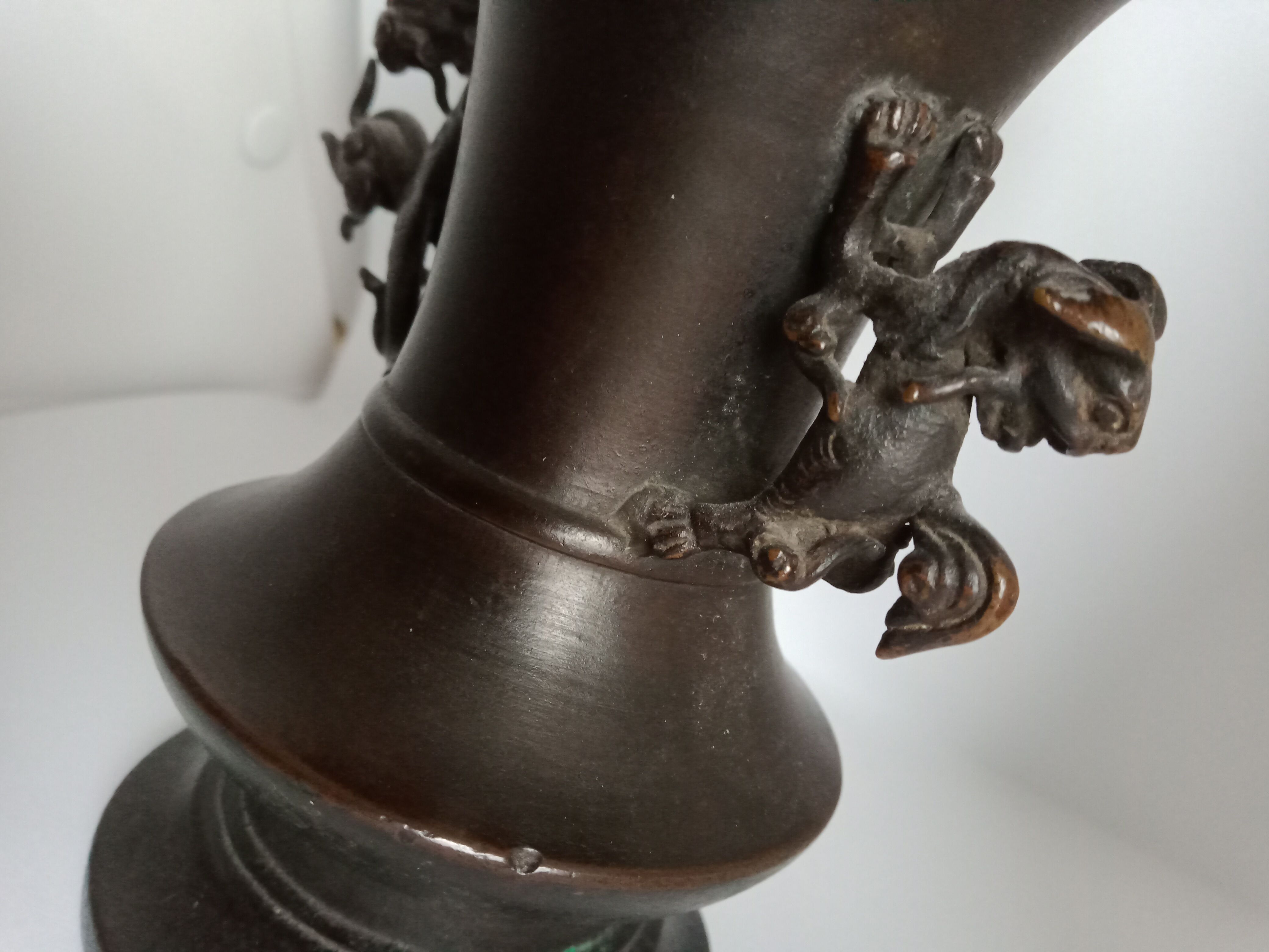 Chinese bronze vase with brown patina decorated with dragon and pho dog