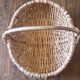 Light wicker oval basket with vintage round handle