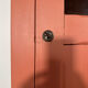 Antique glass-fronted terracotta cupboard