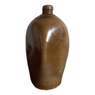 Old bottle of mineral water in salt stoneware