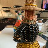 Braided bottle in anthropomorphic wicker