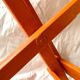 Vintage folding chair in orange painted wood