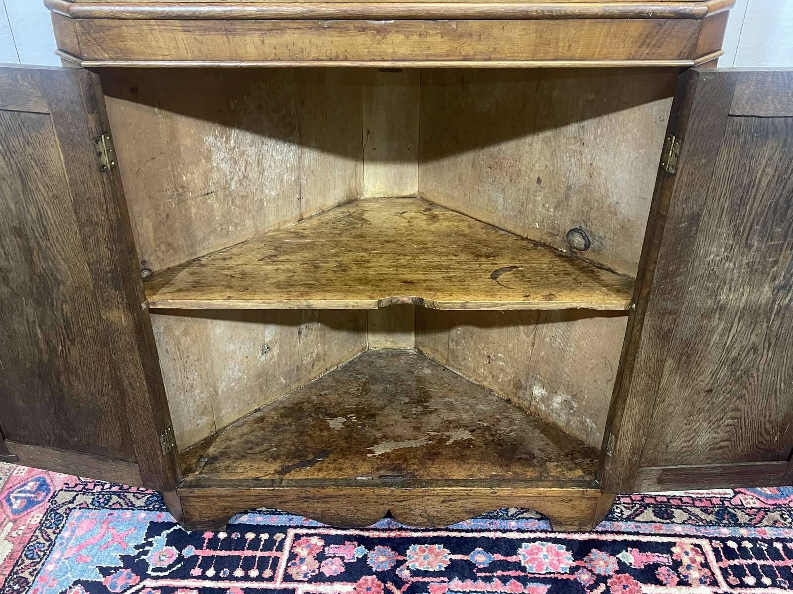 19th-century English corner cabinet in oak, mahogany, and fir.