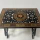 Blackened wood display table with marquetry top, Spain, 19th century.