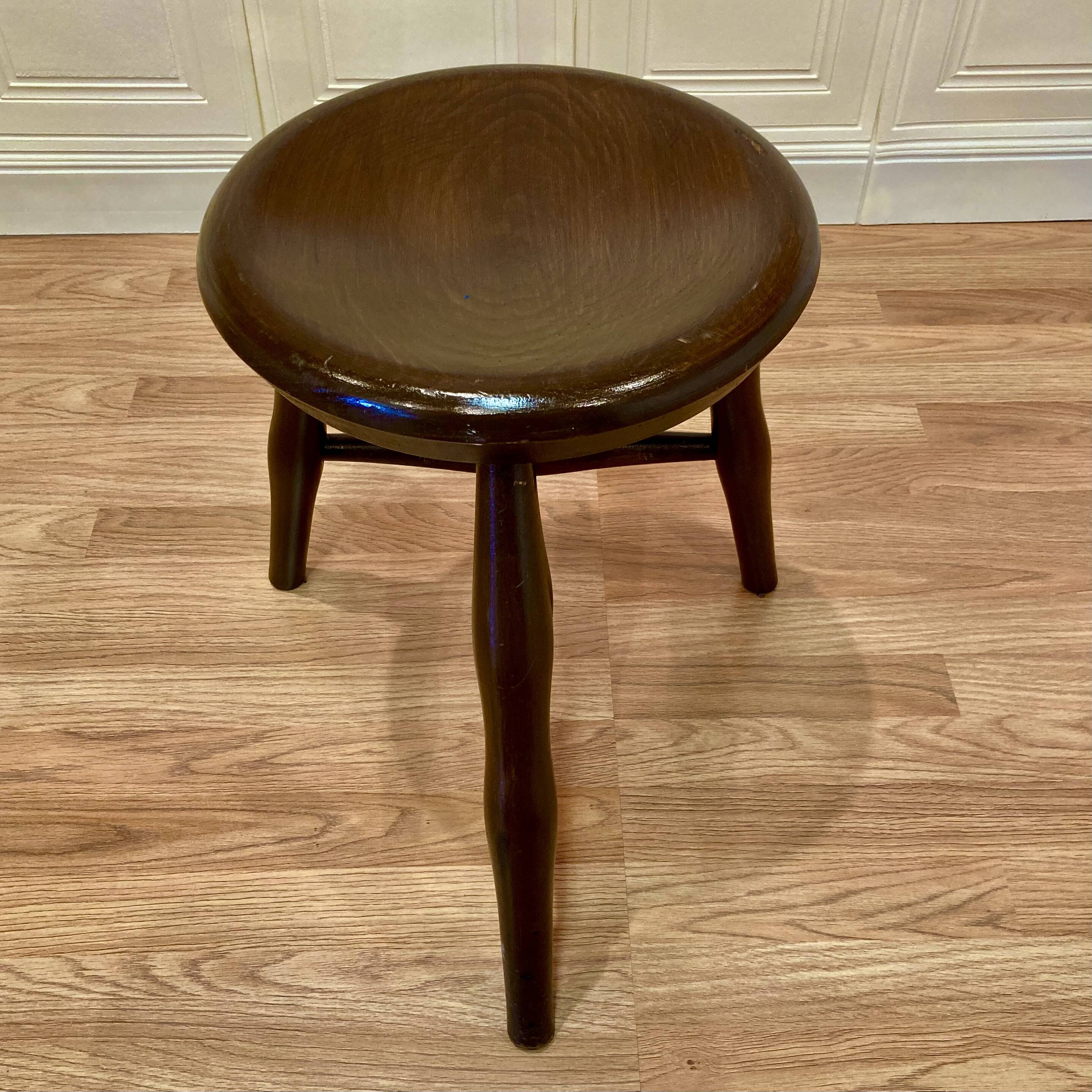 A pair of tripod stools from the period.