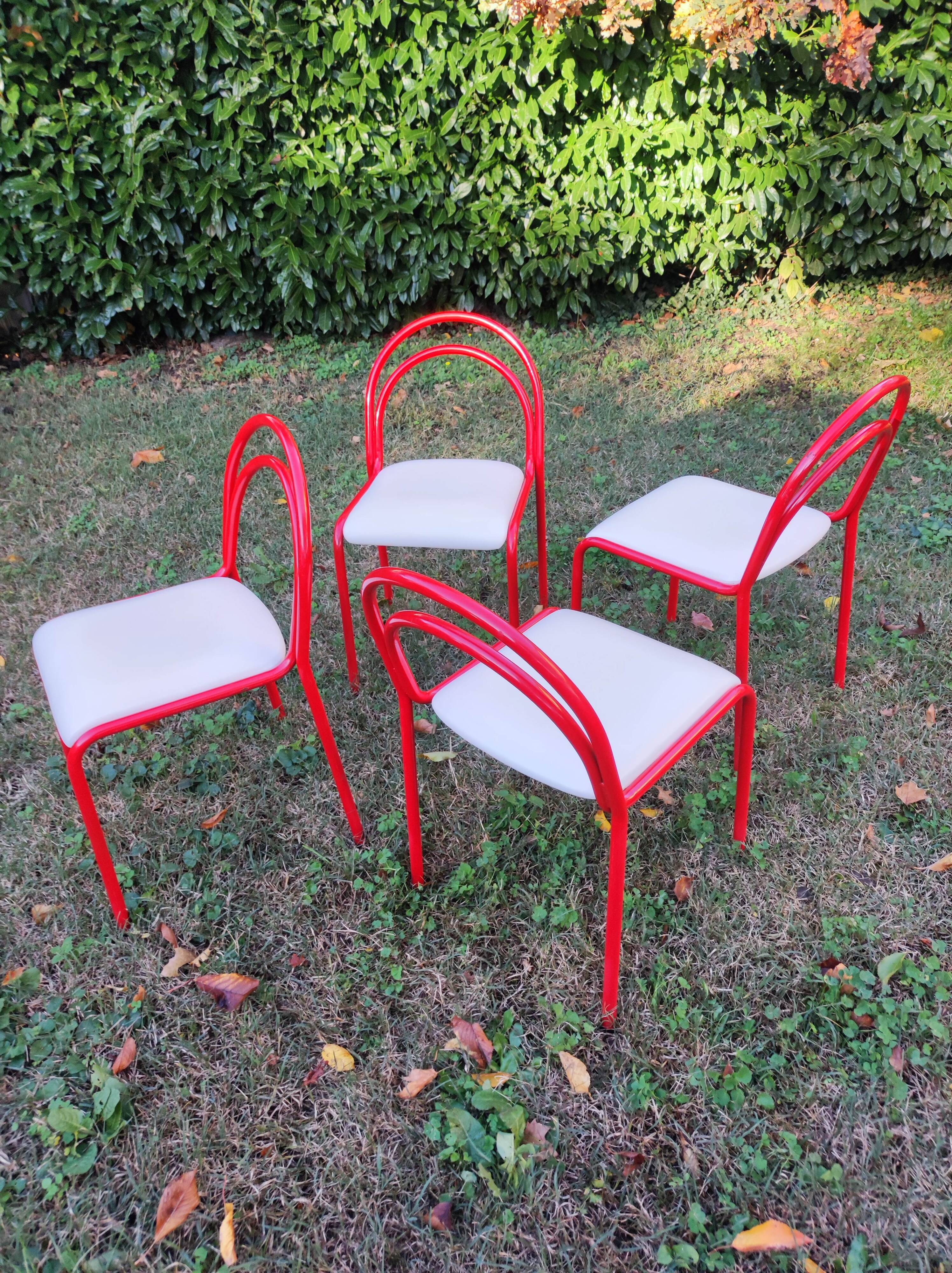 Stackable chairs, Italy, 1980s, red metal, white vinyl