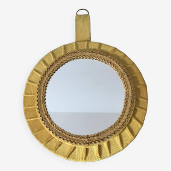 Old round mirror in velvet frame and gold-colored trimmings