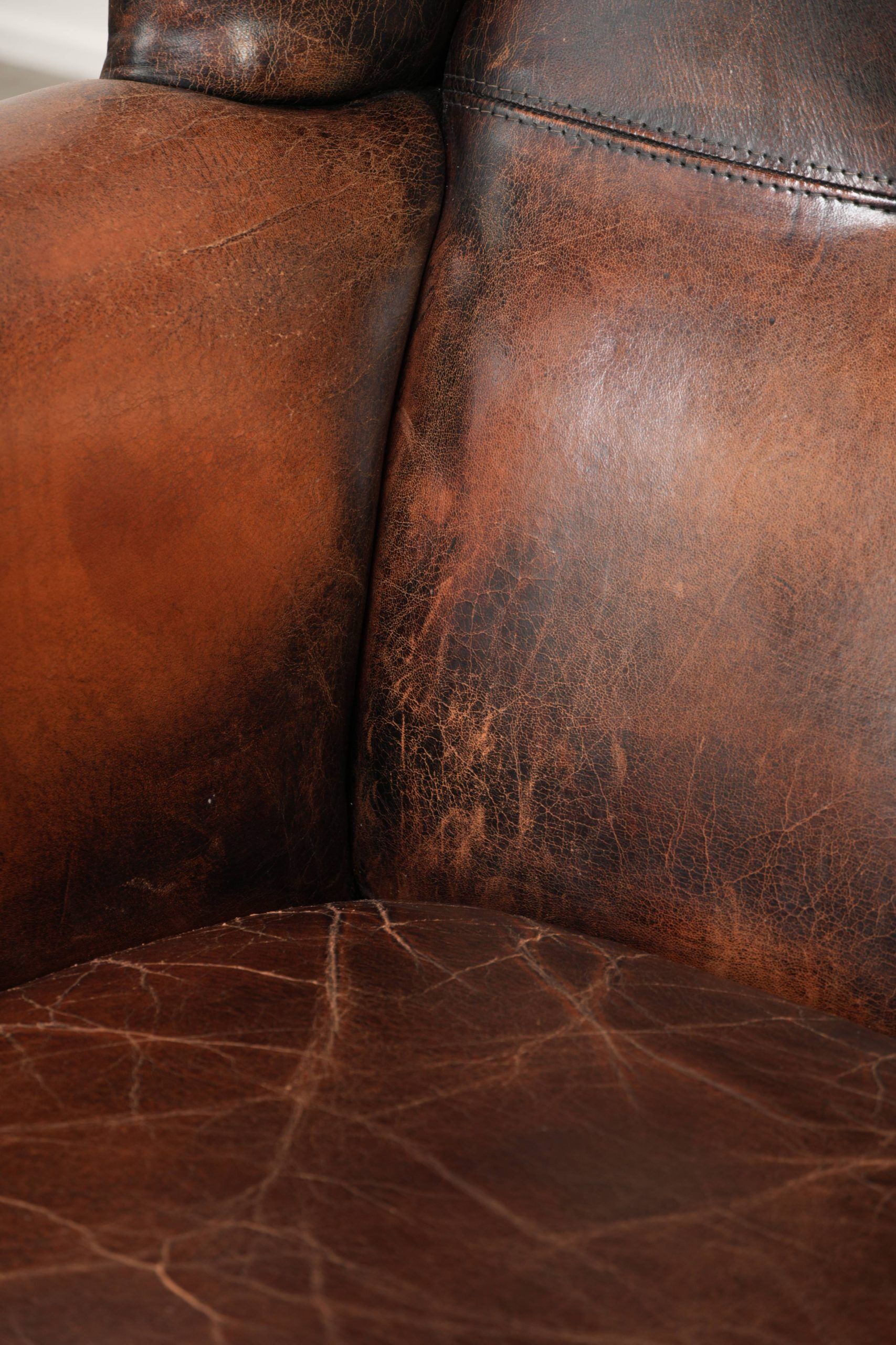Vintage sheepskin wingback armchair in a deep brown colour finished