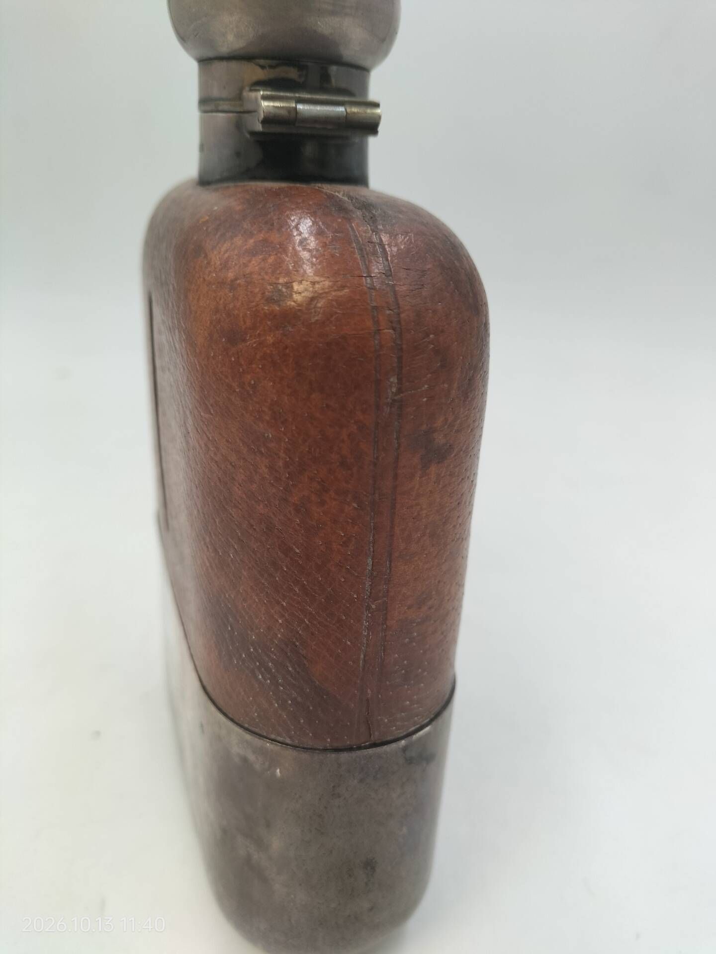 Silver-plated metal flask with leather and glass