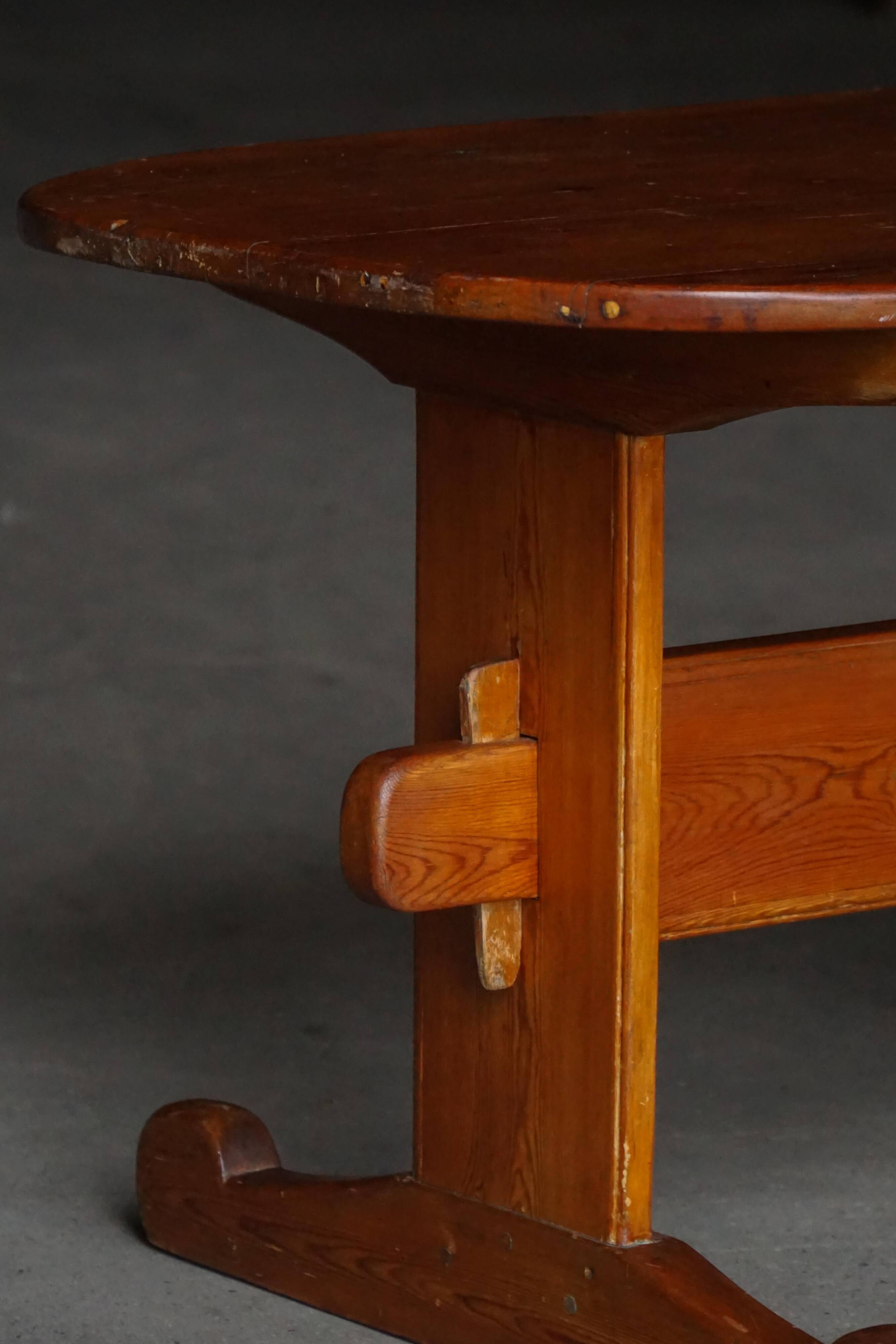 Primitive Swedish oval dining table in pine, early 20th century.