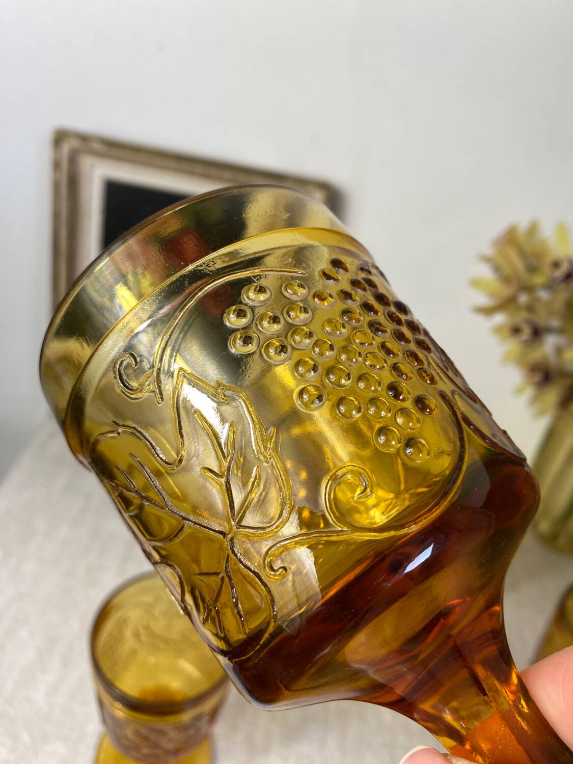Six amber-colored stemmed glasses
