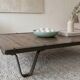 Industrial coffee table made of solid wood and old railway tracks.