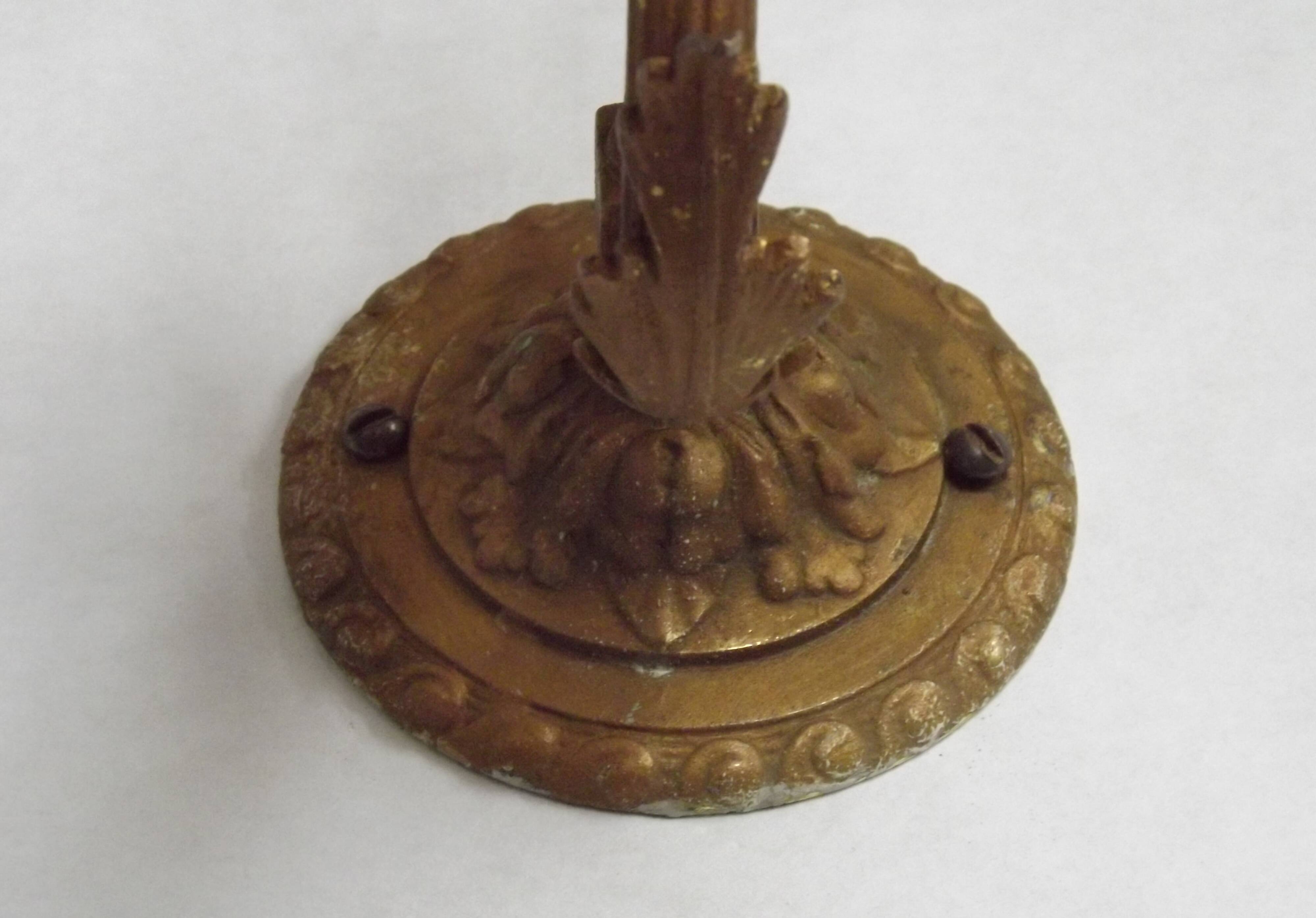 French Art Nouveau wall sconce in bronze with a white and pink glass shade.