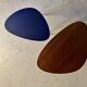 A pair of tripod and nesting coffee tables in walnut and midnight blue.