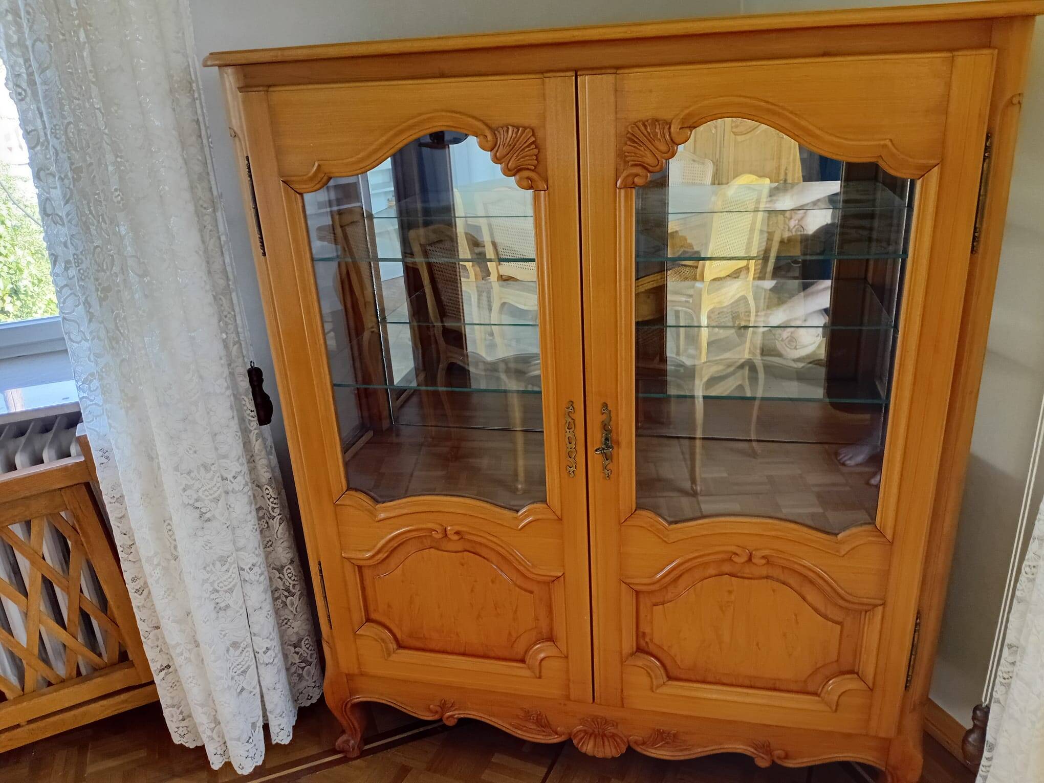 Showcase with shell mouldings in wood, glass, and mirror.