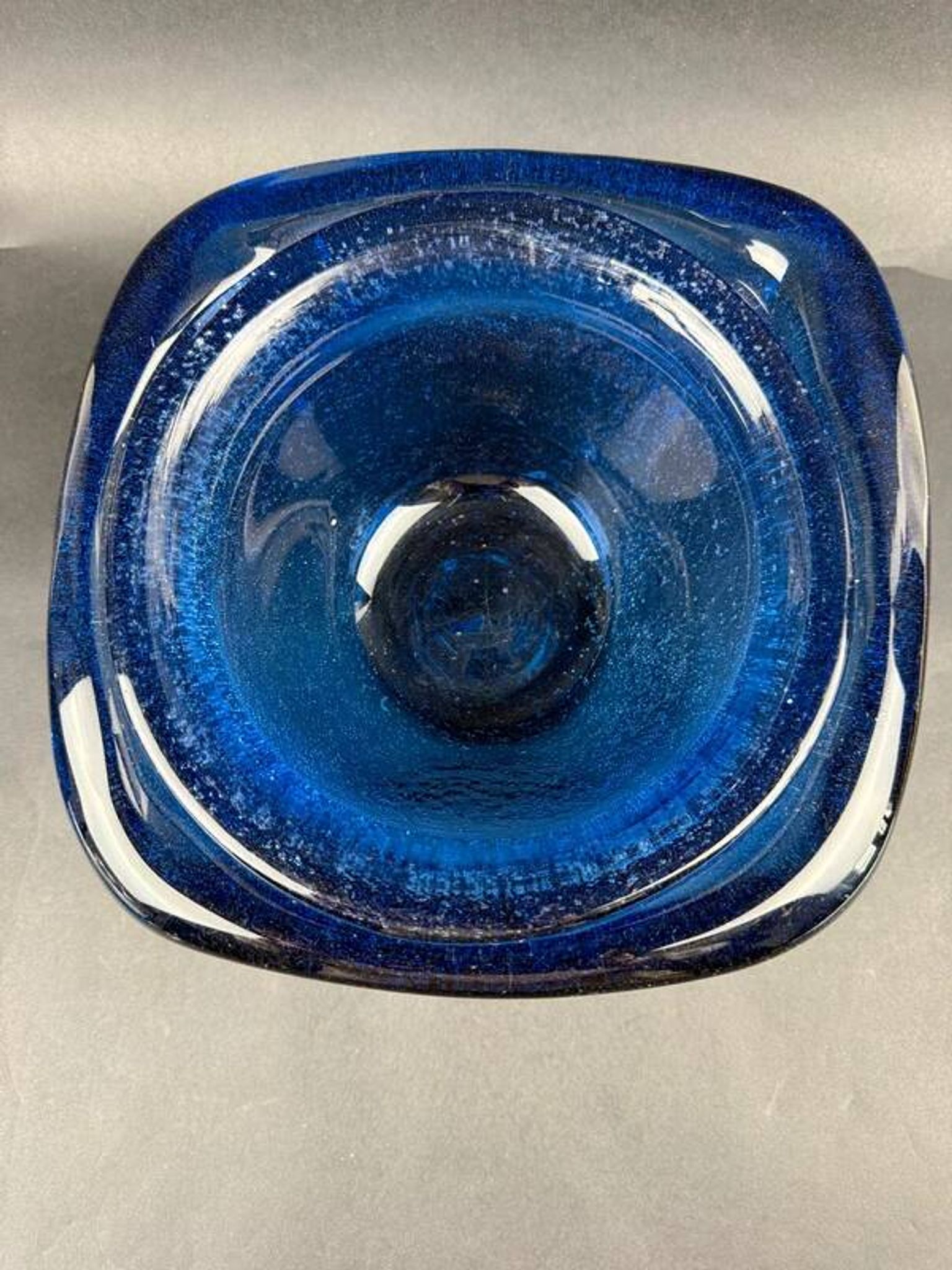 Mortar and pestle in the style of Biot, hard blue.