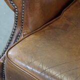 Charming sheep leather wingback armchair with a beautiful patina and excellent seating comfort