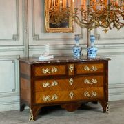 Louis XV style commode in rosewood and palisander veneer, gilt bronze mounts, and Rance marble top.
