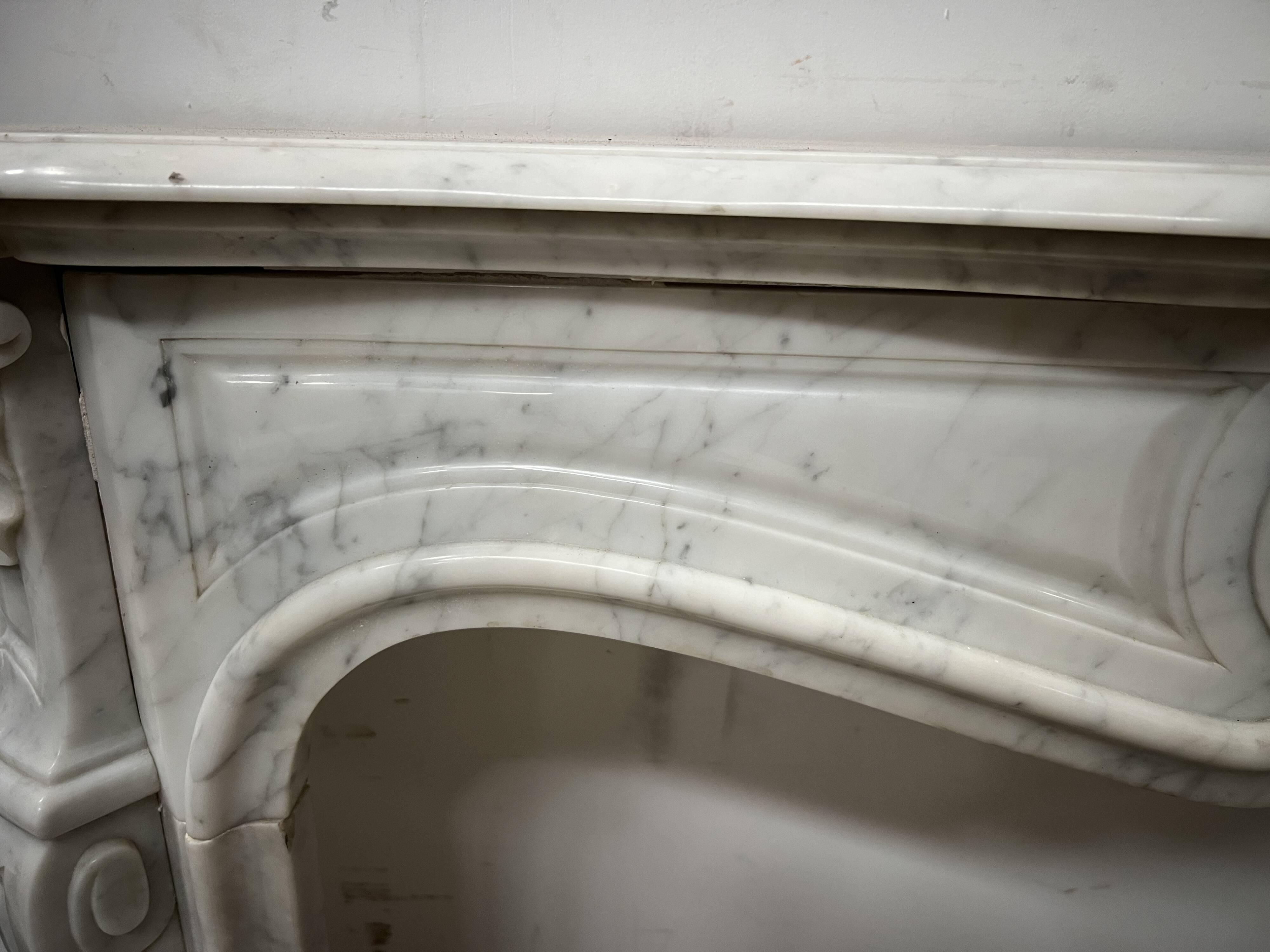 Louis XV style fireplace in veined white marble, 20th century.