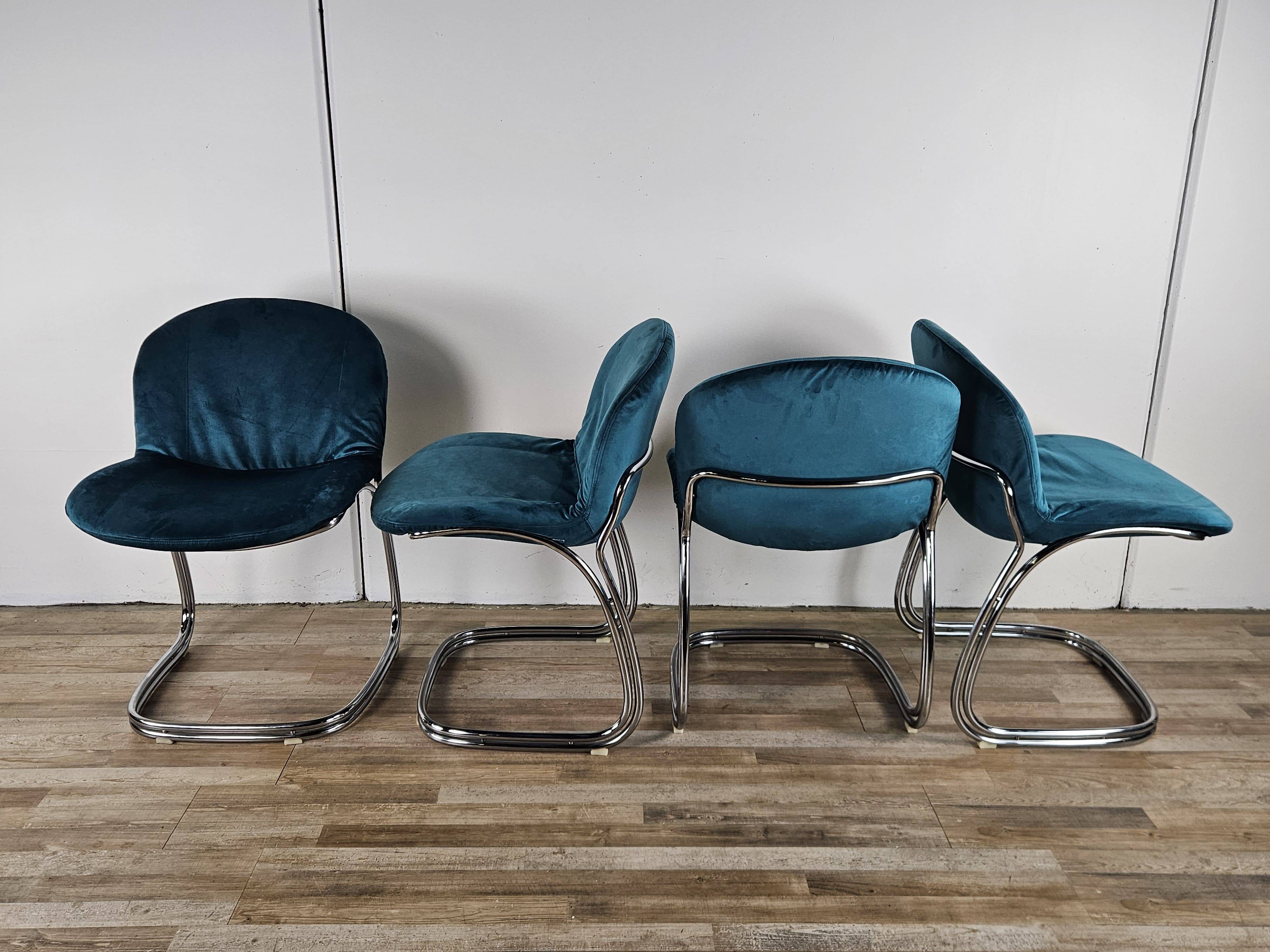 Four 1970s tubular chairs upholstered in blue velvet