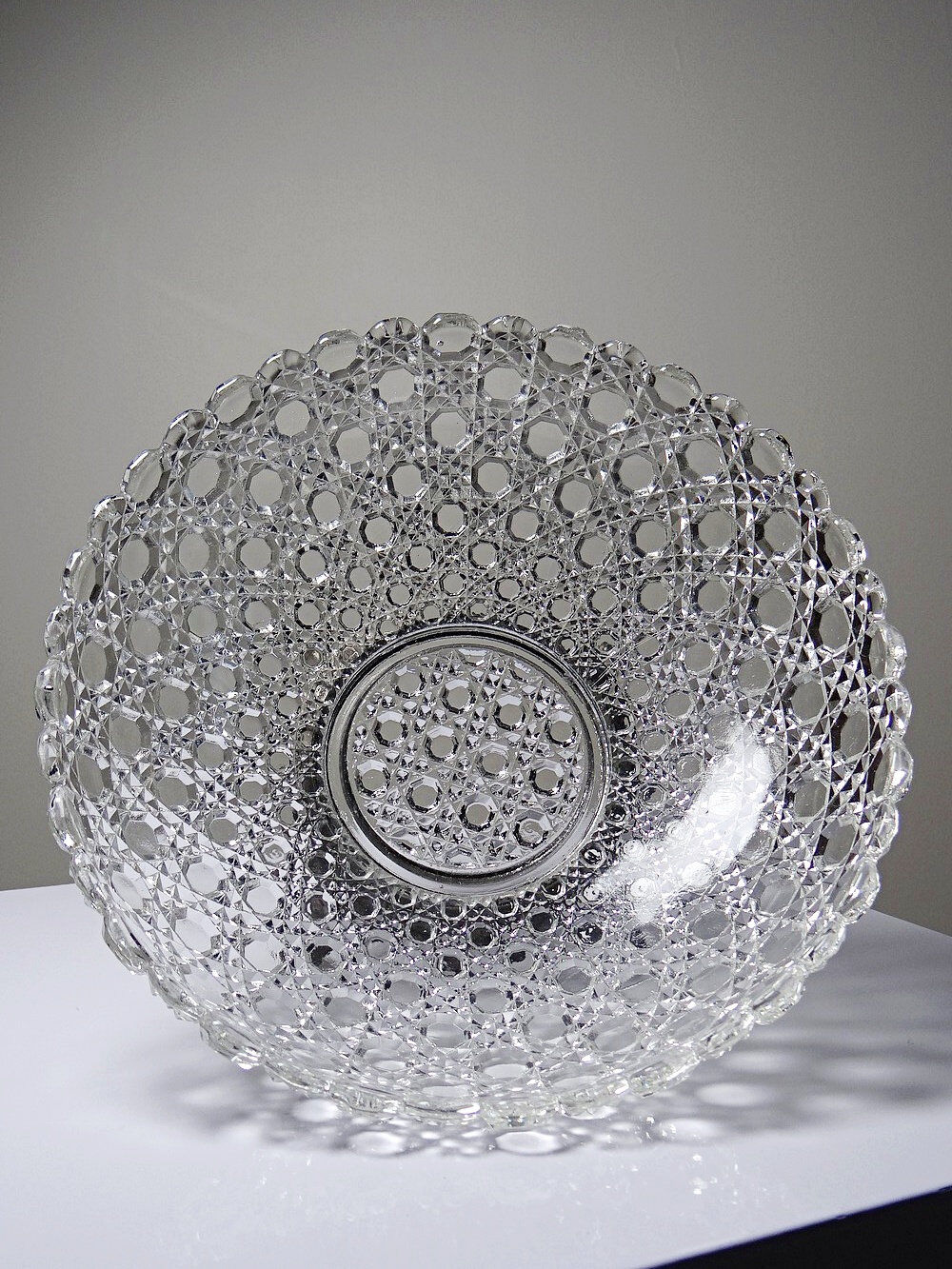 Pressed glass coupe with diamond points, antique from 1920-1950 on a pewter base.