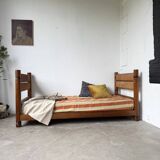 Brutalist style bed with chain and straw