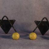 Pair of vintage black wrought iron and yellow wood coat hooks 1950