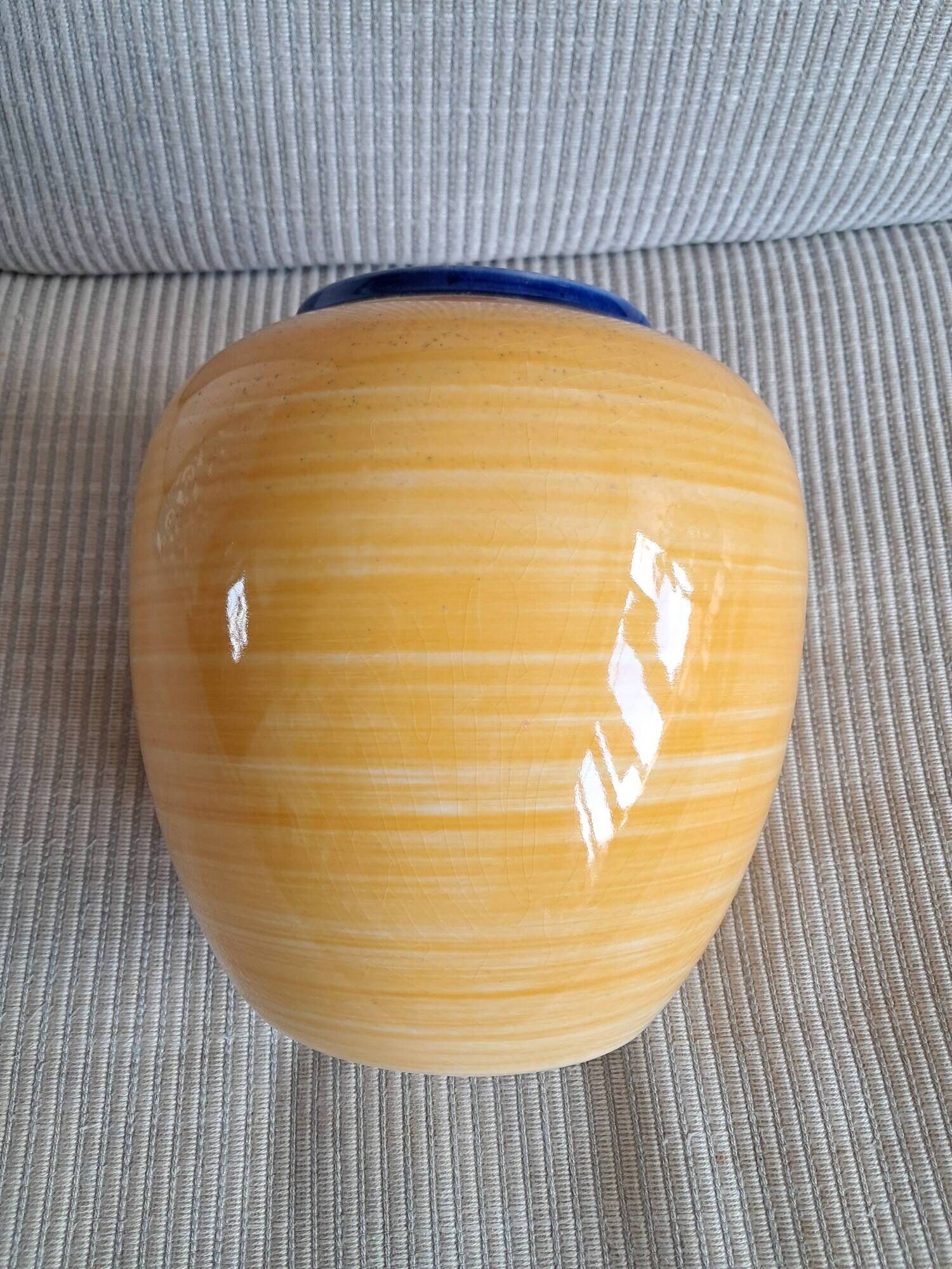 Vintage ceramic vase in a round shape.