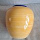 Vintage ceramic vase in a round shape.