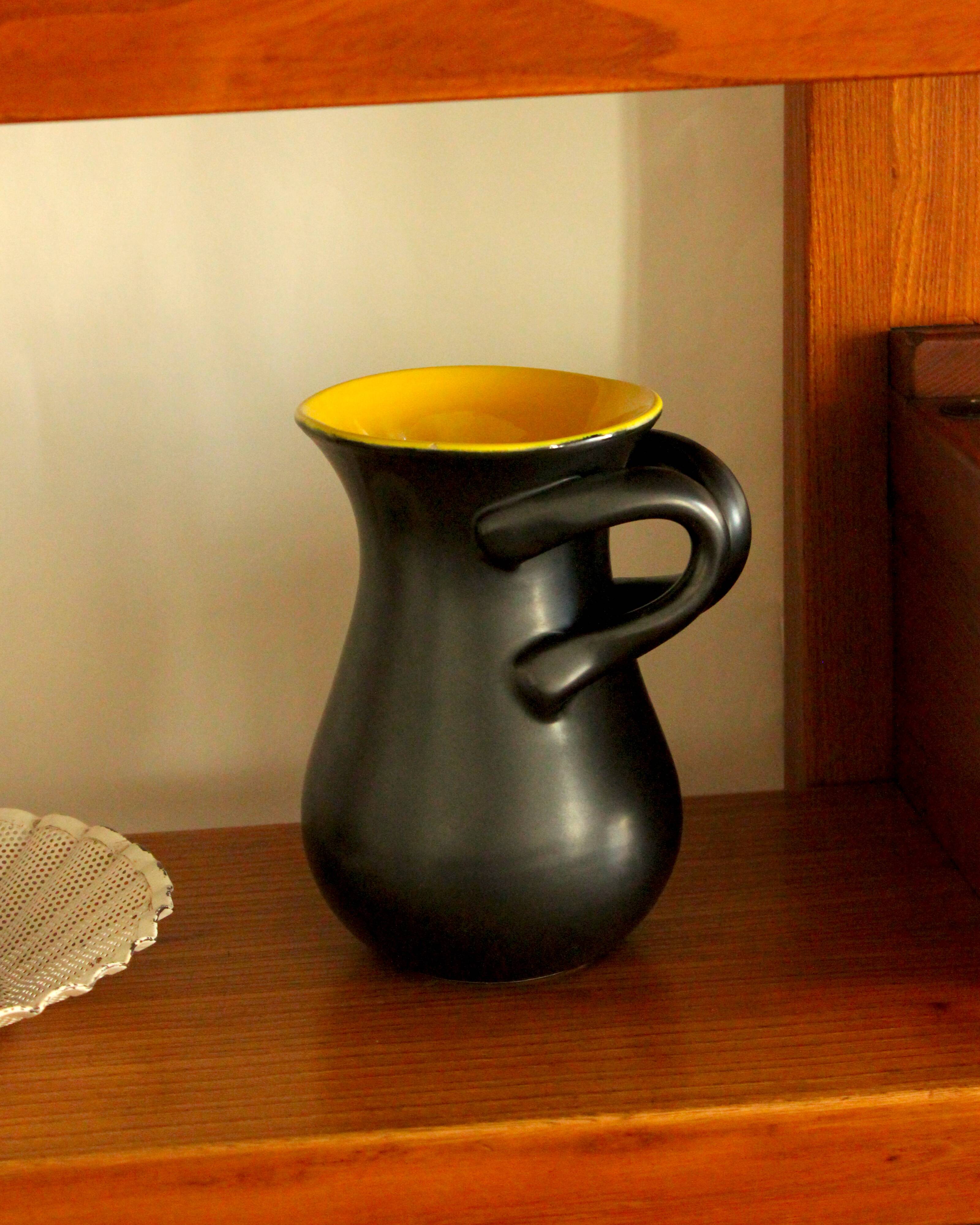 Glazed ceramic vase in black and yellow, in the style of Pol Chambost.