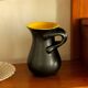 Glazed ceramic vase in black and yellow, in the style of Pol Chambost.