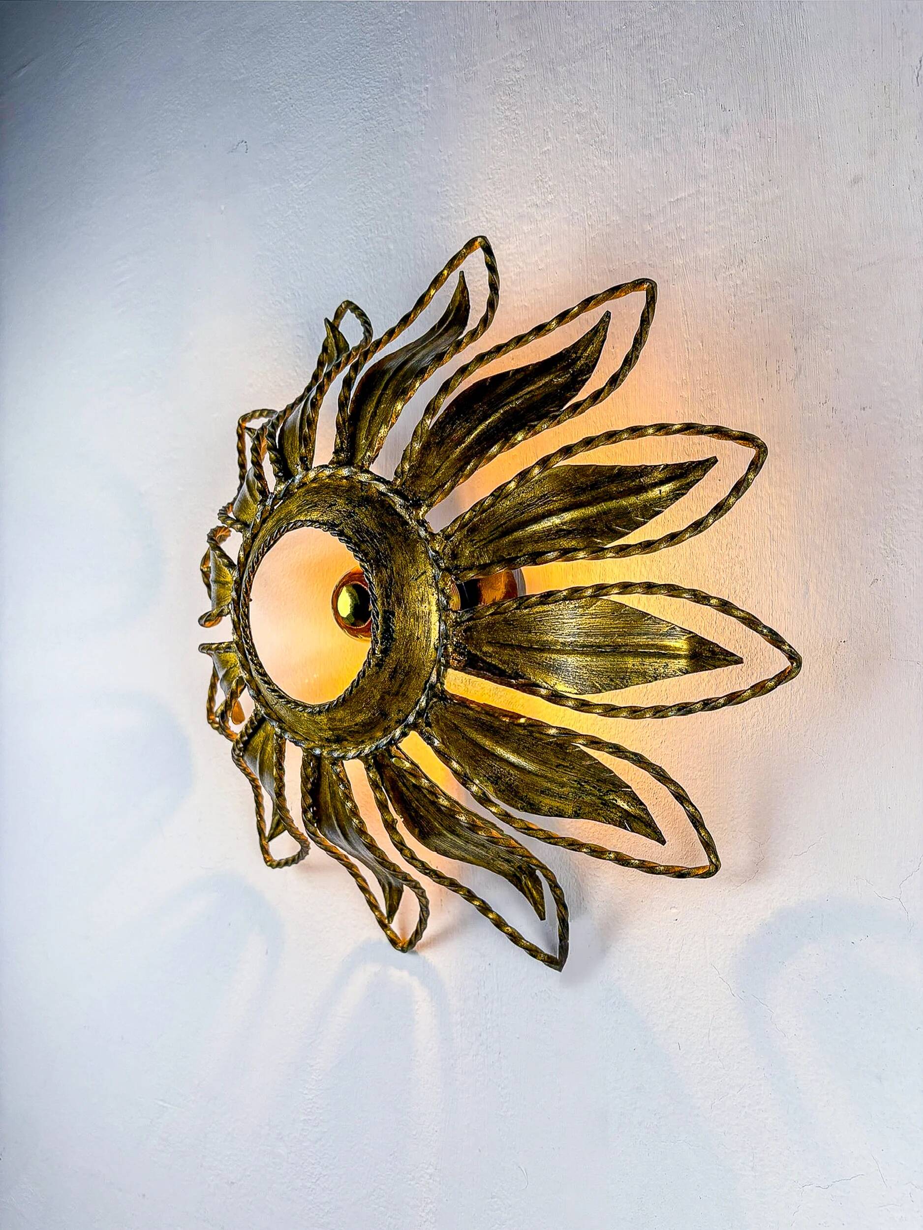 Sunburst ceiling light fixture or sconce, gilt iron & exposed bulb France, 1970s