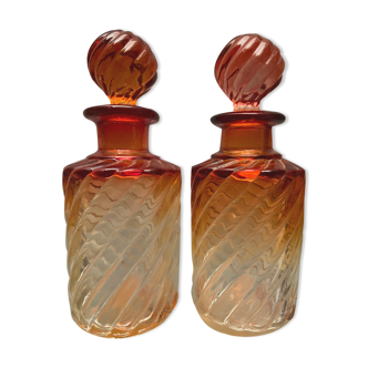 Pair of Baccarat twisted tinted crystal bottles