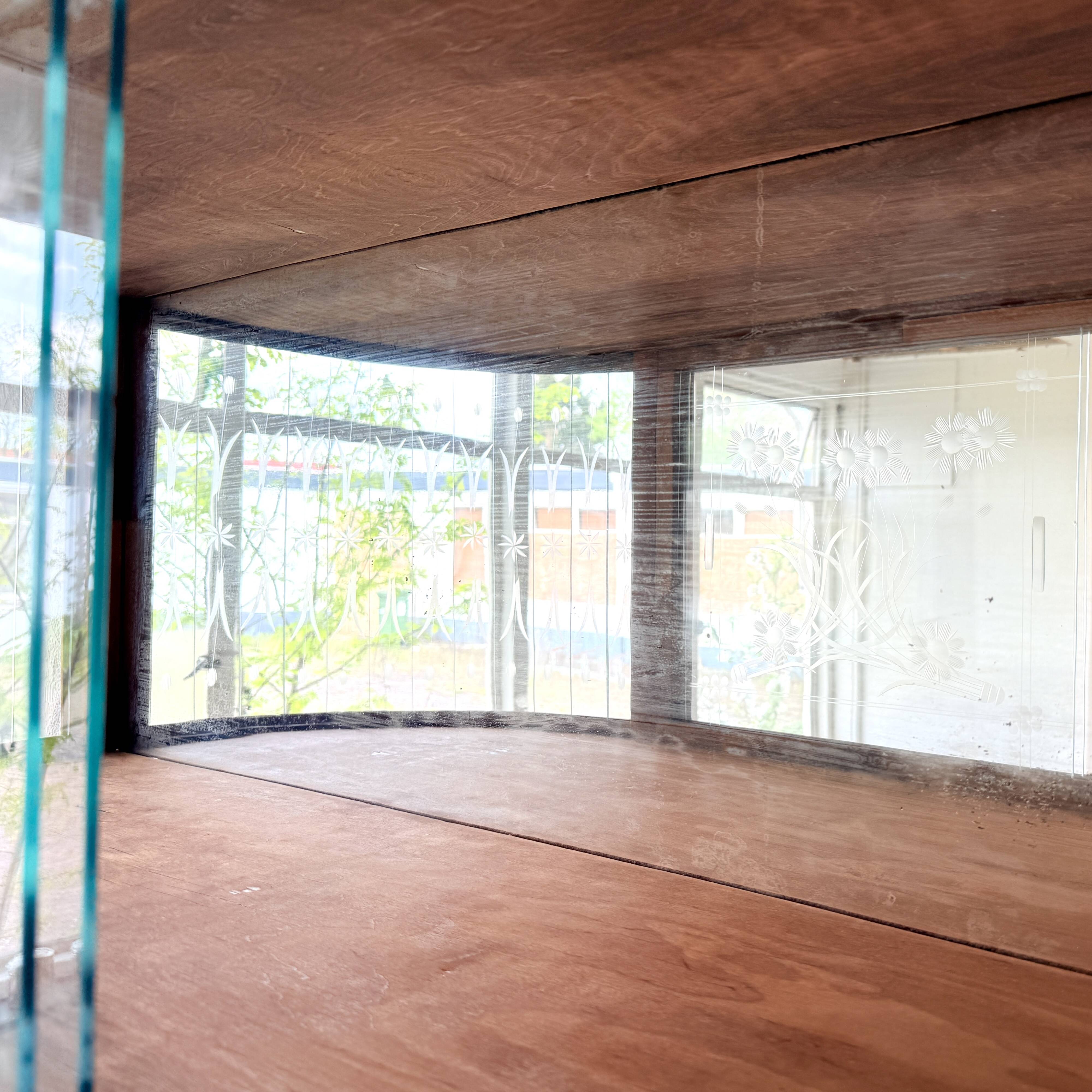 Art Deco-style wall-mounted display cabinet with floral engraving