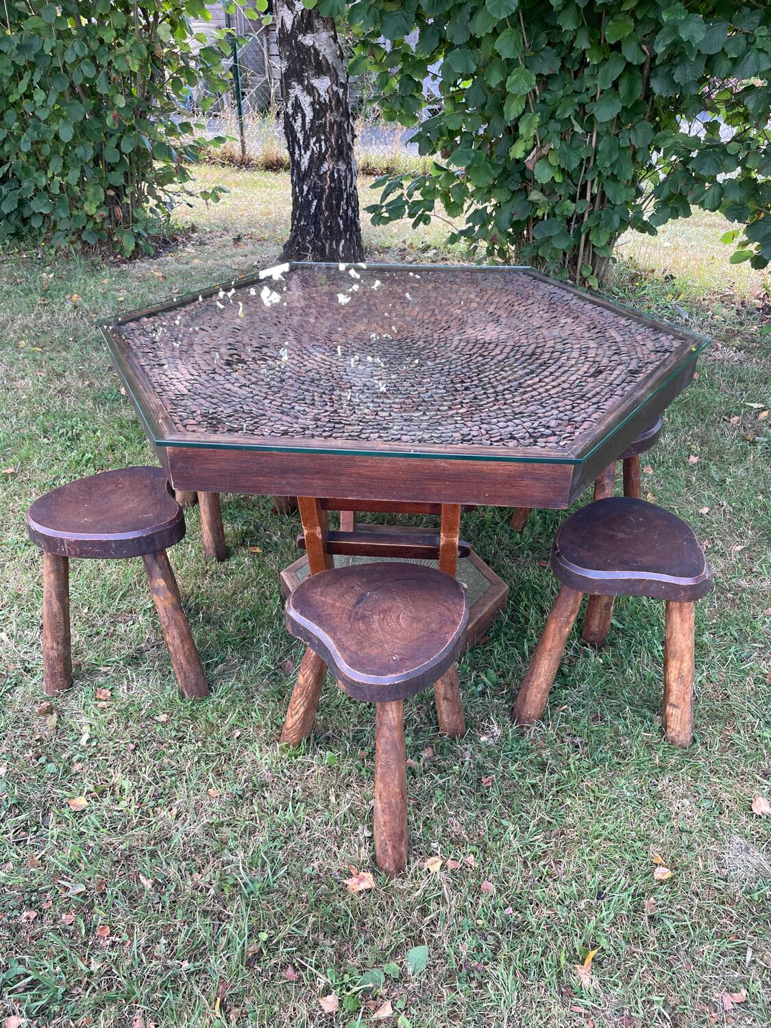 Handcrafted hexagonal wooden table with natural decor.