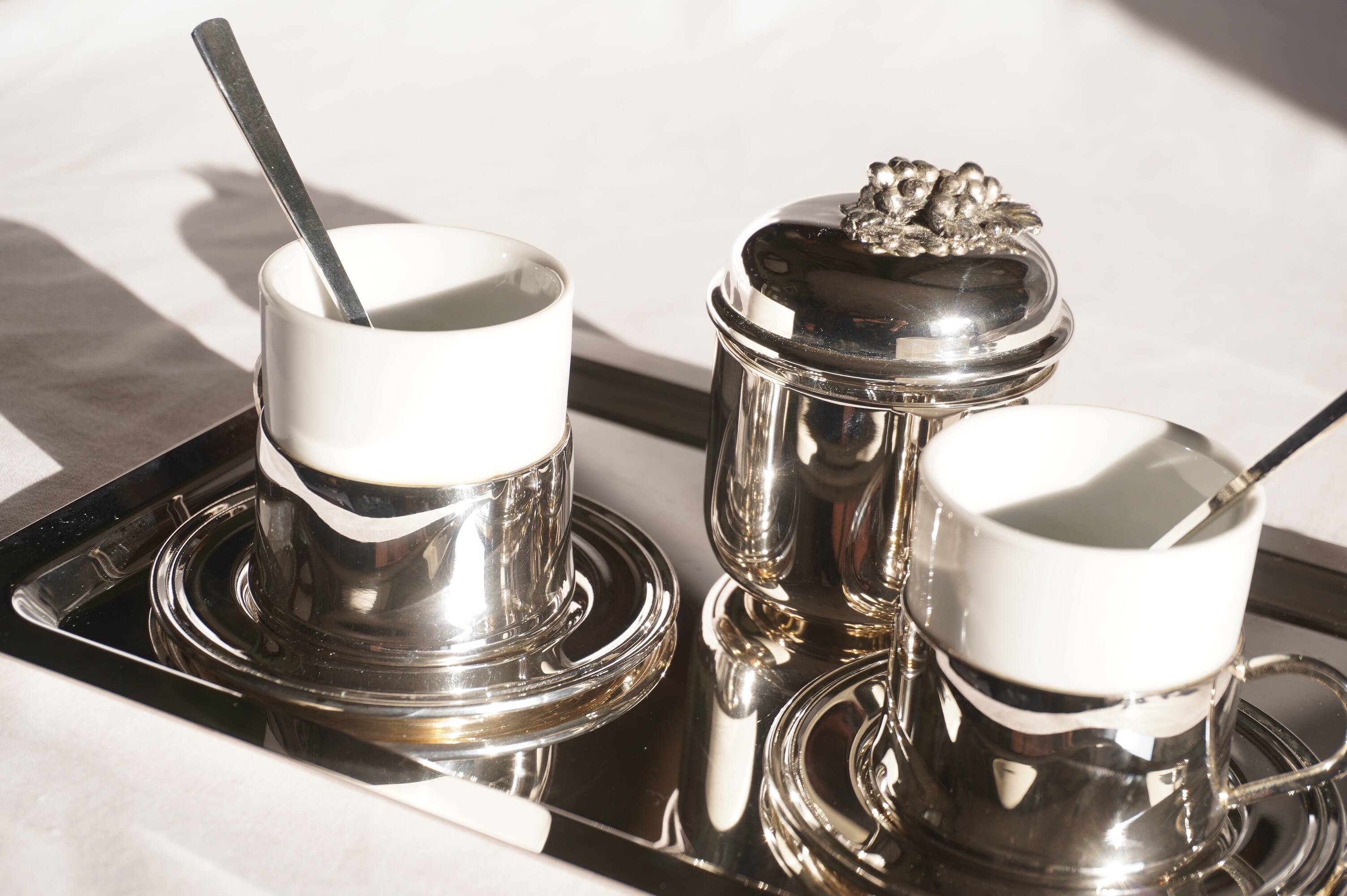 Silver-plated metal coffee service with a grape design.