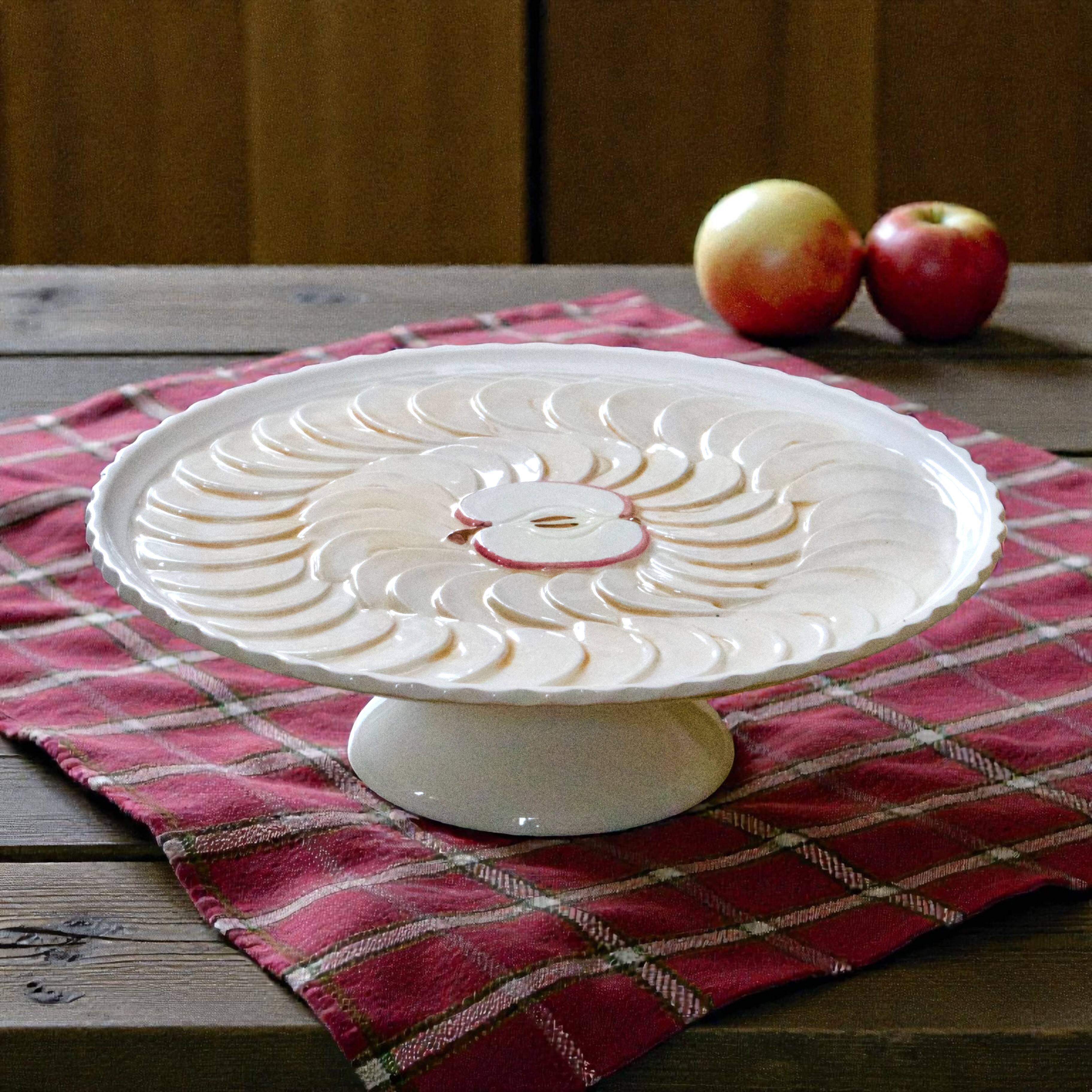 Large vintage earthenware pie dish on a pedestal, apple pie