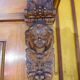 Antique carved wooden sideboard with several sculptures.